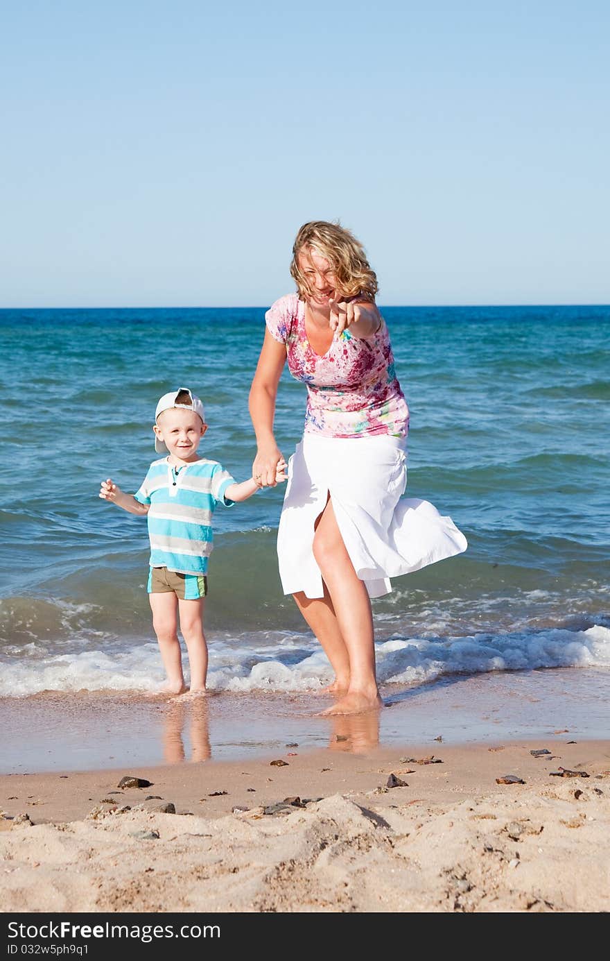 Mother and son  on the beach.