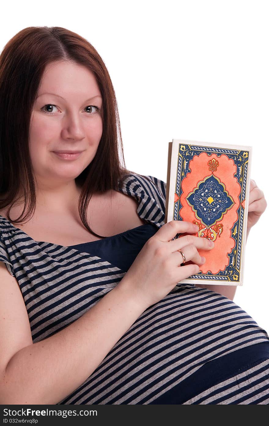 Pregnant woman reading a book in a rocking chair, isolated on white