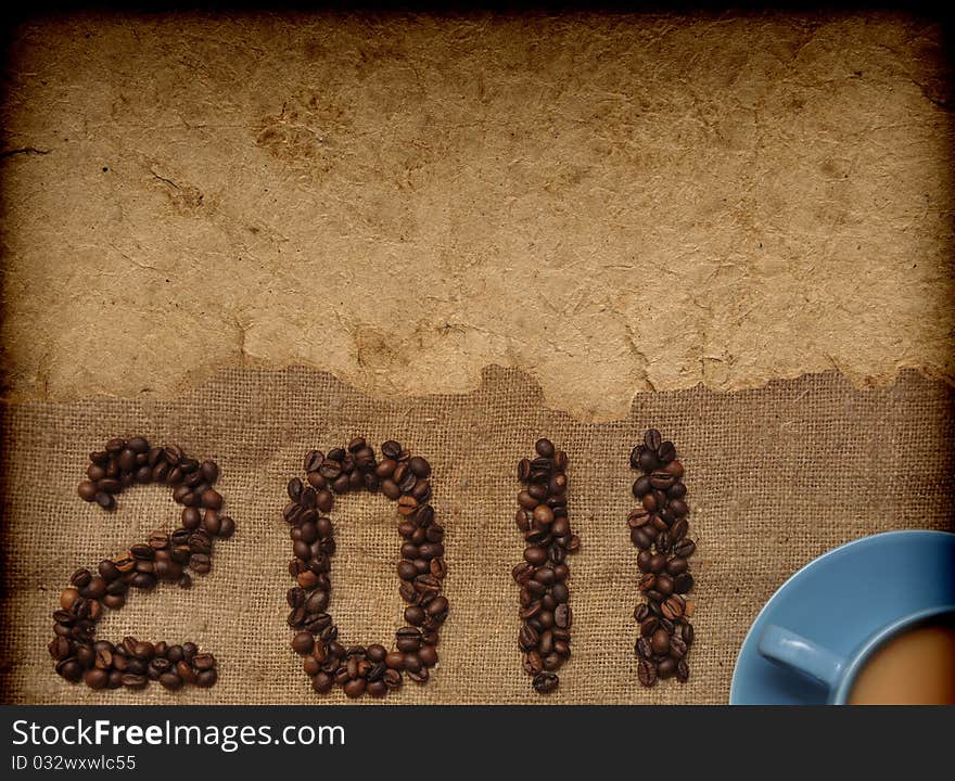 Coffee with granules and new year 2011 on old paper