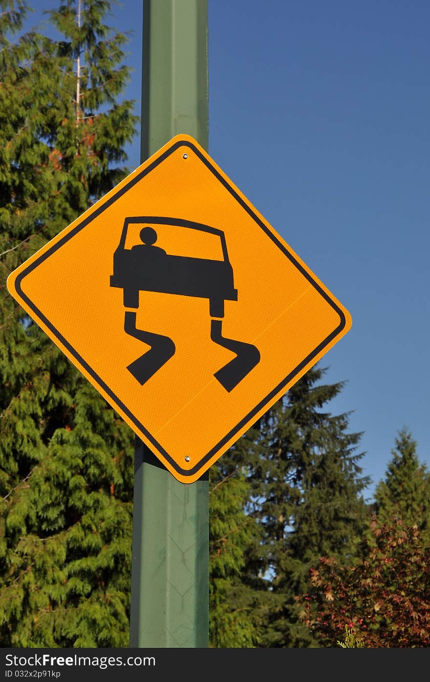 Slippery road sign with nature view