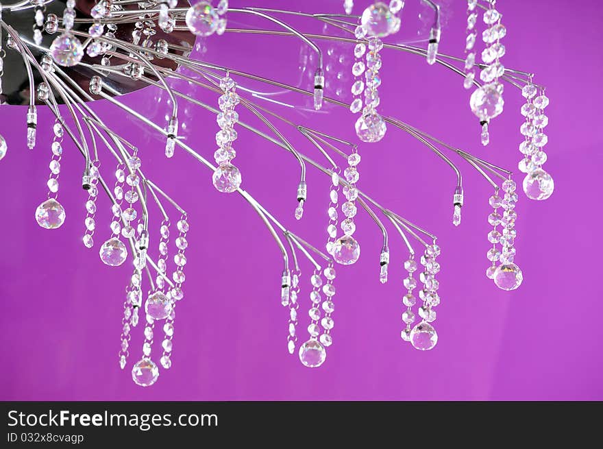 Graceful chandelier on a lilac ceiling at restaurant. Graceful chandelier on a lilac ceiling at restaurant.