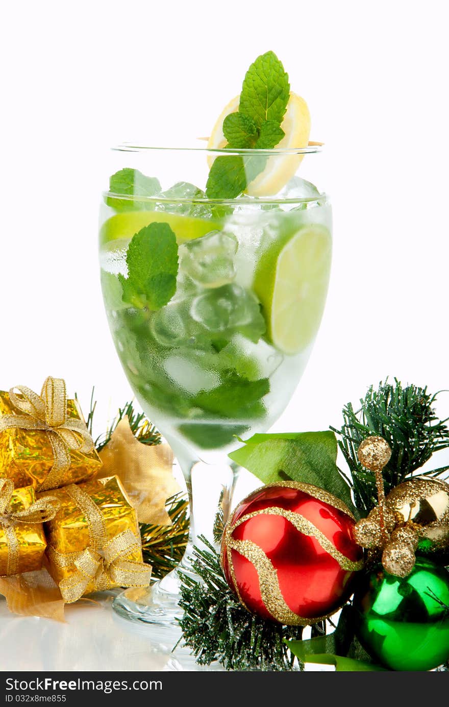 Mojito Party Club Cocktail with mint leaves, vodka, lime, simple syrup, light bacardi rum, club soda and candy cane and christmas New Year ornament decoration isolated on a white background. Mojito Party Club Cocktail with mint leaves, vodka, lime, simple syrup, light bacardi rum, club soda and candy cane and christmas New Year ornament decoration isolated on a white background