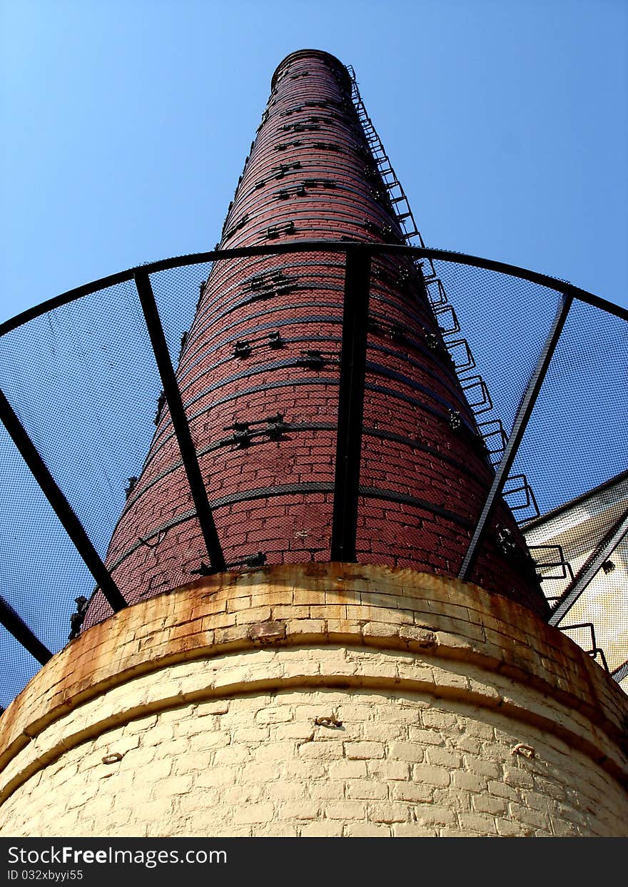 Pipe in the production runs into the blue sky. Pipe in the production runs into the blue sky