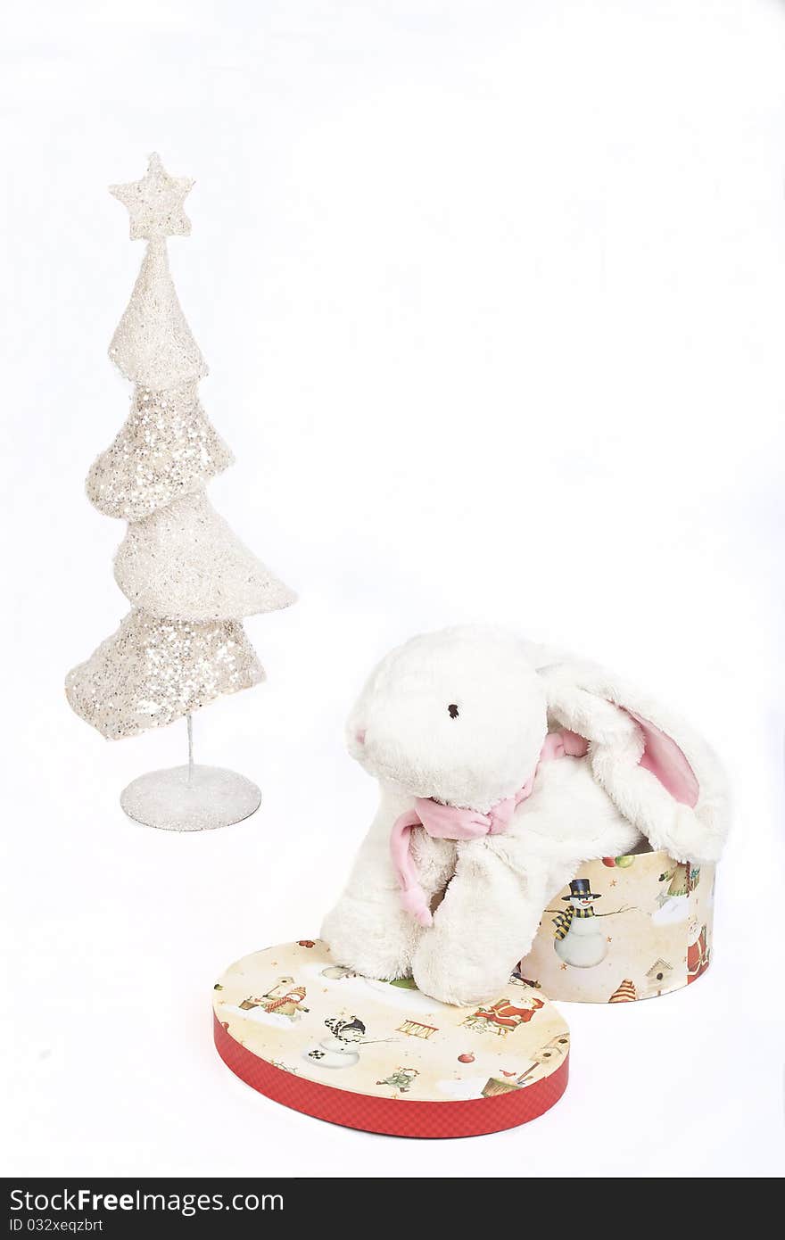 White Christmas tree and a toy white rabbit in a gift box symbol 2011