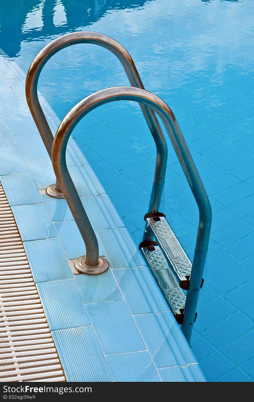 Steel handrails and stairs in the swimming pool. Steel handrails and stairs in the swimming pool