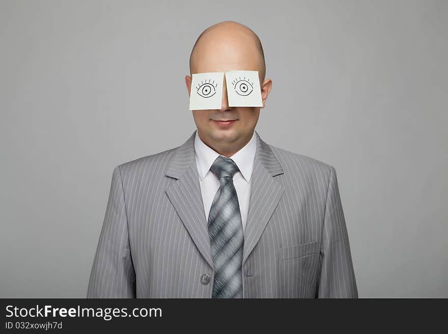 Bald businessman in a gray suit