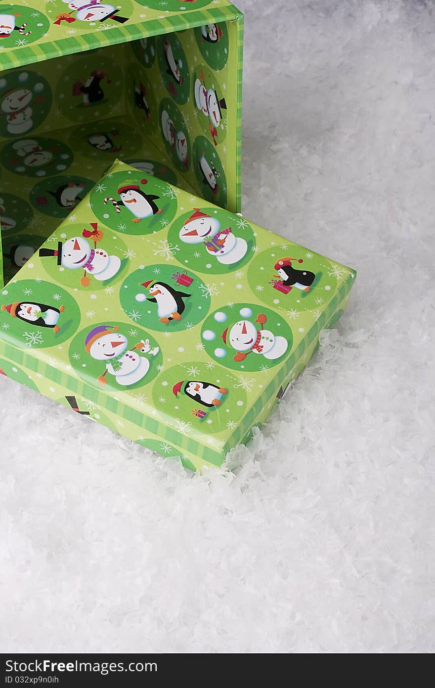 Green gift box for Christmas on a background of decorative snow.