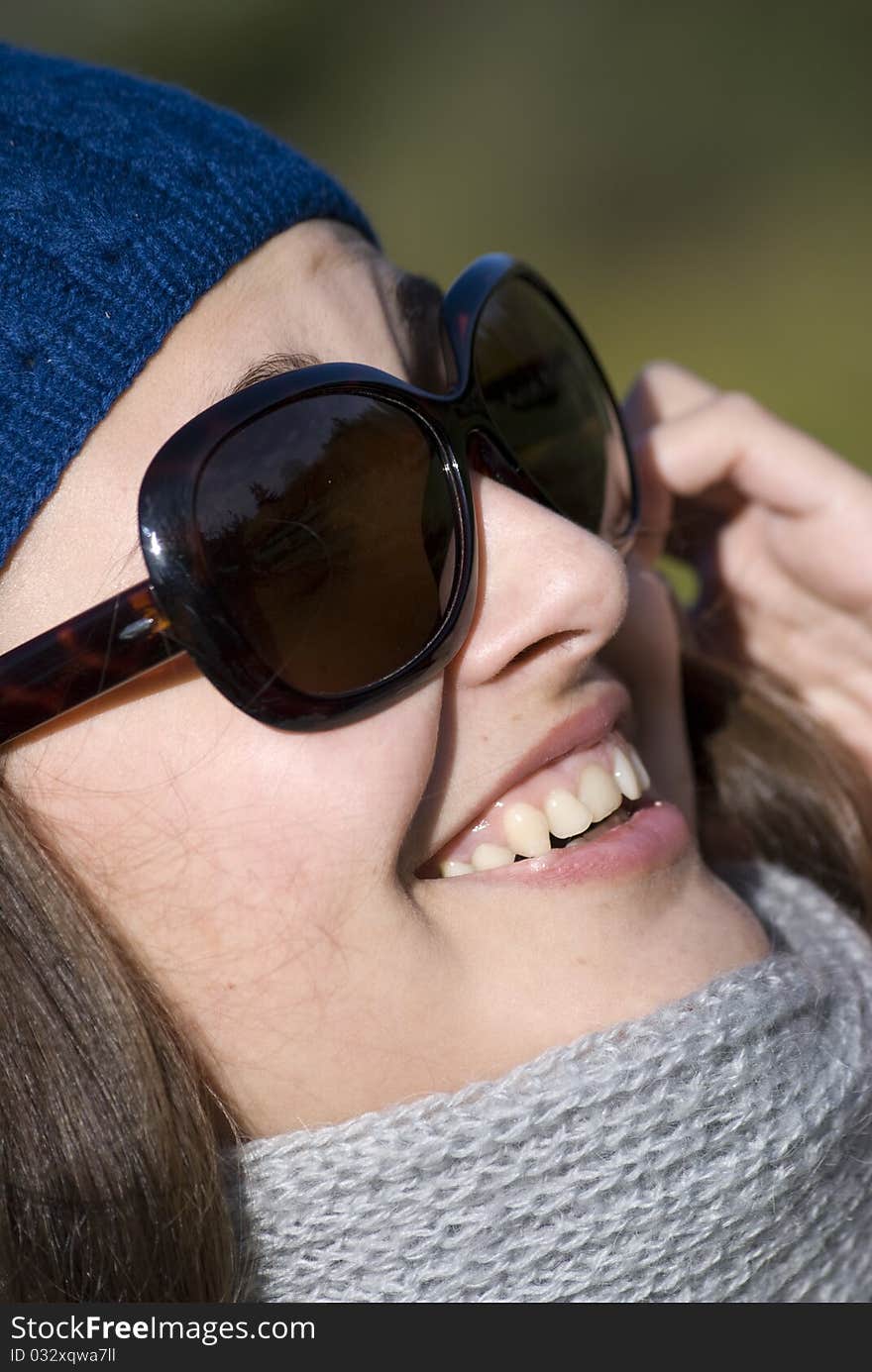 young woman wearing spectacles speaks by phone. young woman wearing spectacles speaks by phone