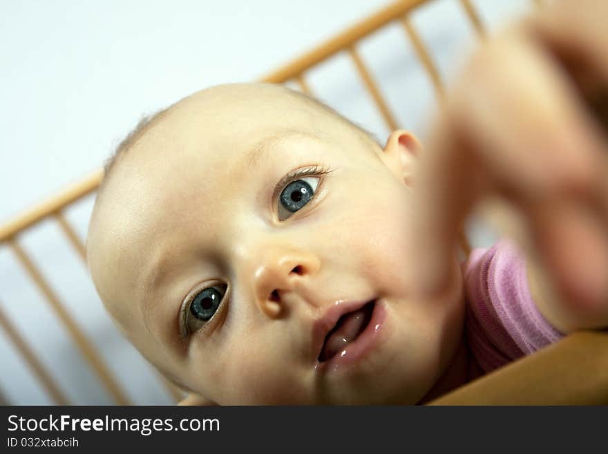 Baby sees her reflection in the lens and is pleased to. Baby sees her reflection in the lens and is pleased to