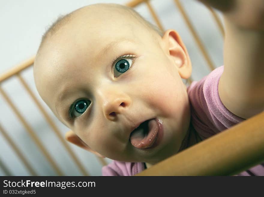 12 month old baby looking to me and shows me her tongue. 12 month old baby looking to me and shows me her tongue