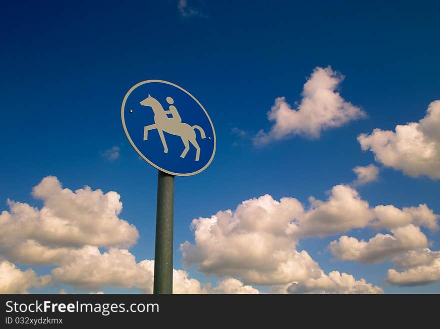 A road sin for riders in the clear sky with cotton wool clouds in germany. A road sin for riders in the clear sky with cotton wool clouds in germany