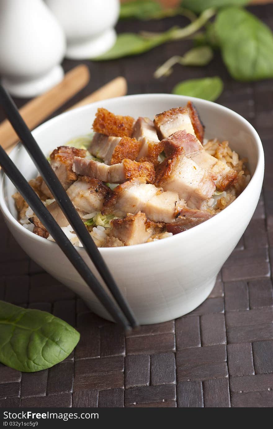 Crispy roast pork with rice in a bowl