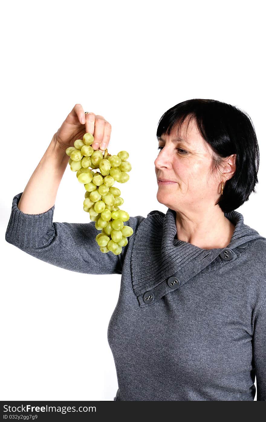 Aged woman with bunch of fresh grapes isolated on white background. Aged woman with bunch of fresh grapes isolated on white background