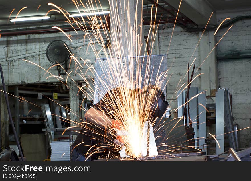 Sparks frying over the working table during metal grinding