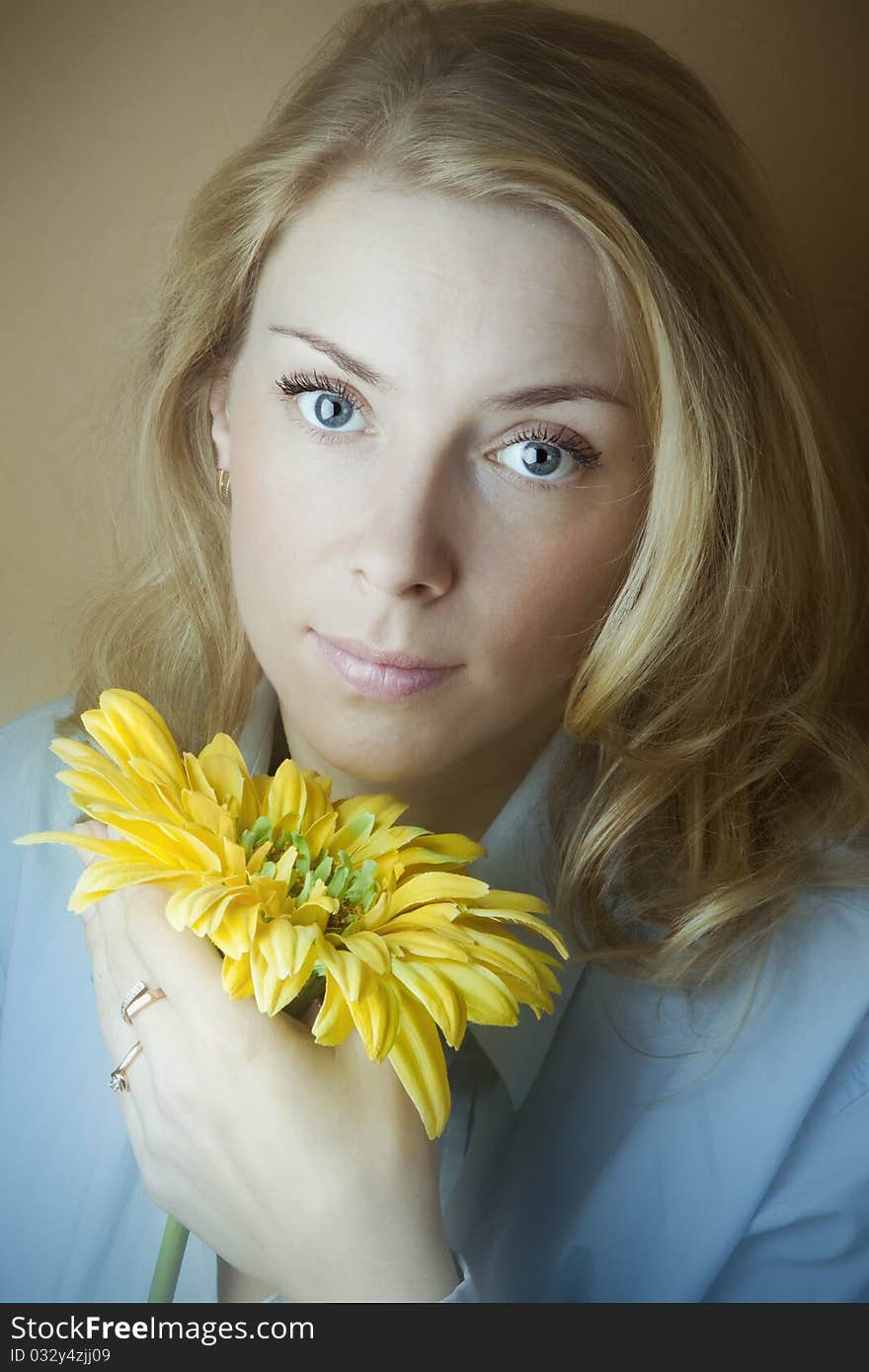 Nice wise woman with a beautiful flower in the hands of