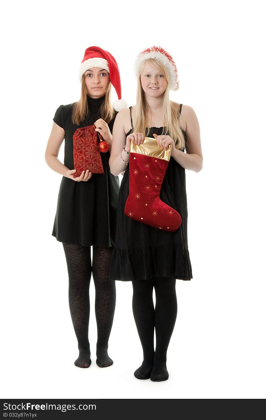 Two girls in the Santa hat and gifts on a white background