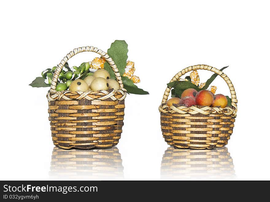 Fruits baskets isolated on white with reflection
