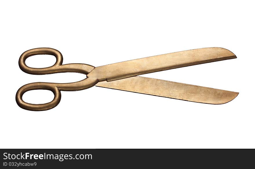 Golden scissors on a white background