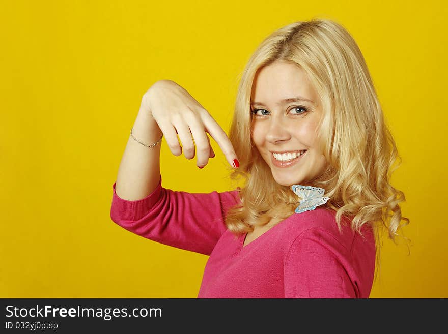 Portrait of a beautiful young woman with a butterfly on a yellow background. Isolated on a white background. Portrait of a beautiful young woman with a butterfly on a yellow background. Isolated on a white background