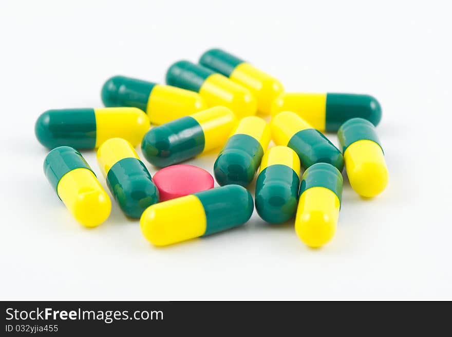 Pink Pills among yellow and green pills