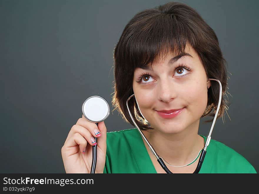 Attractive lady doctor on a over gray background