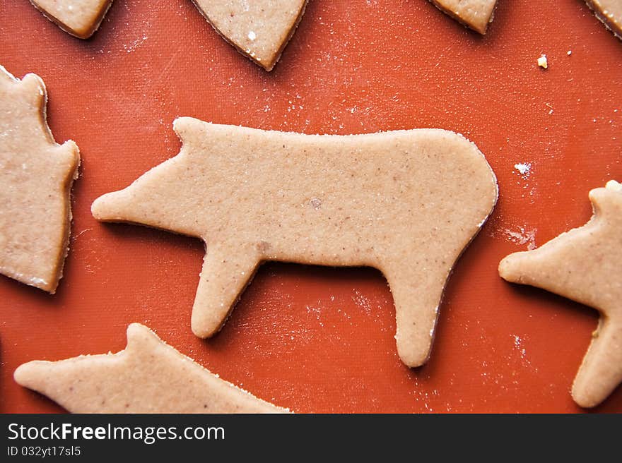 Christmas baking of gingerbread cookies on teflon baking paper. Christmas baking of gingerbread cookies on teflon baking paper