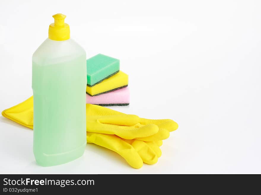 Yellow rubber gloves, vial of cleaning fluid and sponges on white background. Yellow rubber gloves, vial of cleaning fluid and sponges on white background