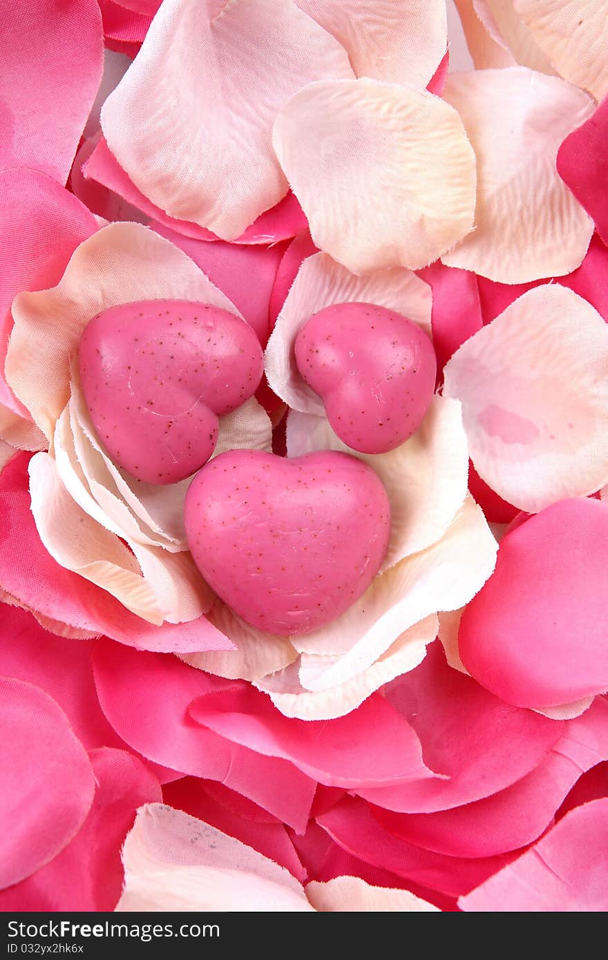 Pink hand made soap heart shaped and pink rose petals. Pink hand made soap heart shaped and pink rose petals