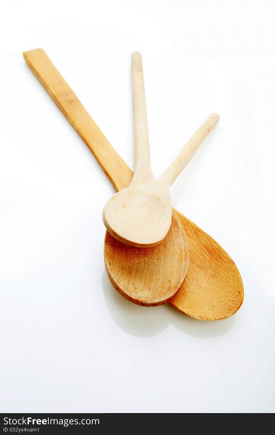 Three kitchen spoons made of wood on the white background. Three kitchen spoons made of wood on the white background