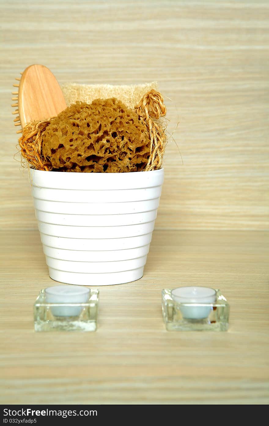 Spa and bath accessories in a bucket placed in on a shelf