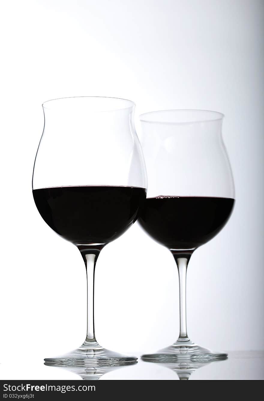 Two red wine glasses half full