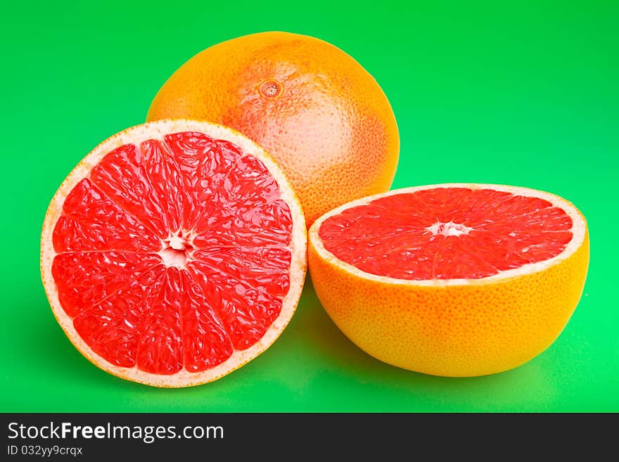 Juicy grapefruit on green background