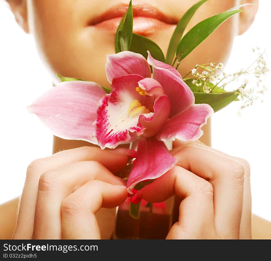 Beautiful girl holding orchid flower in her hands. Beautiful girl holding orchid flower in her hands