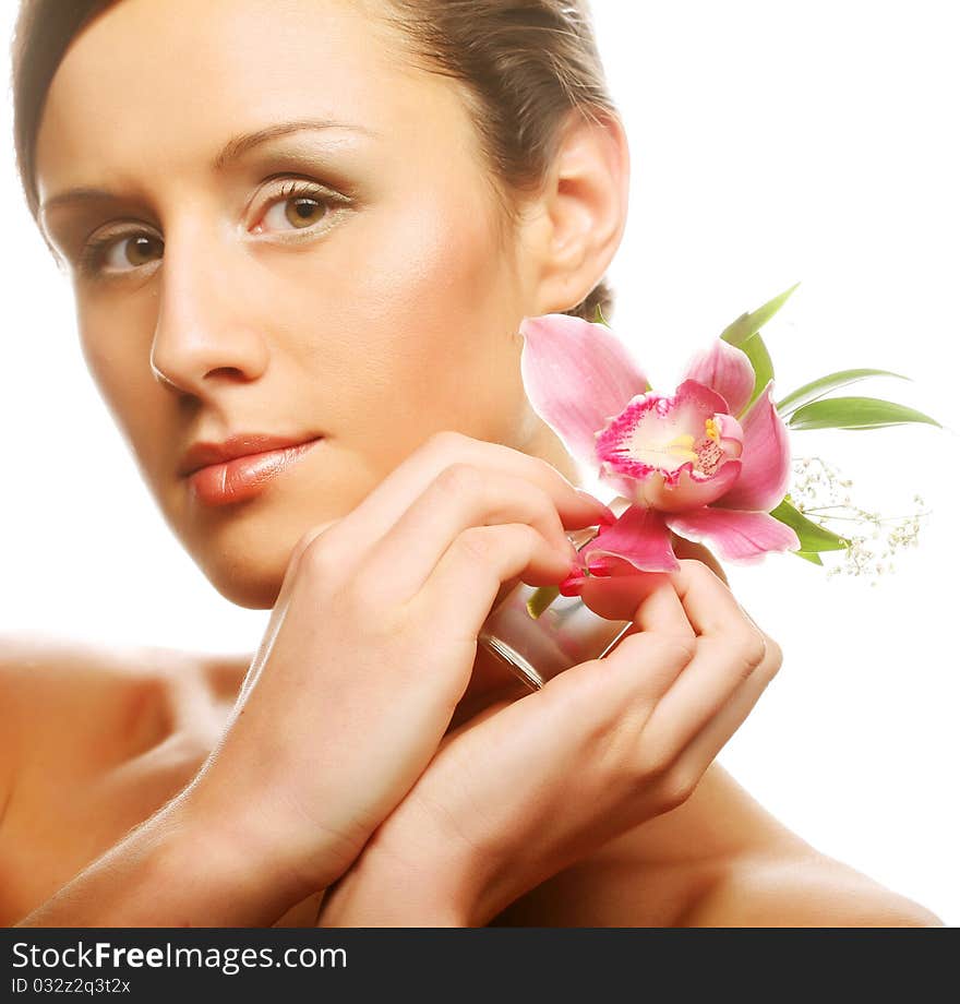 Beautiful girl holding orchid flower in her hands. Beautiful girl holding orchid flower in her hands