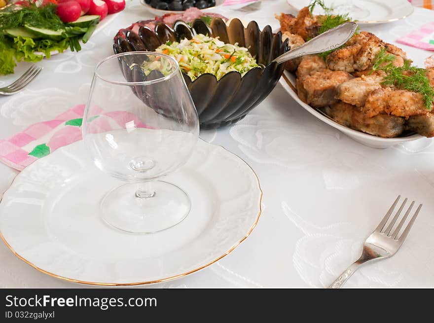 Fried fish and cabbage salad on a dining table. Fried fish and cabbage salad on a dining table.