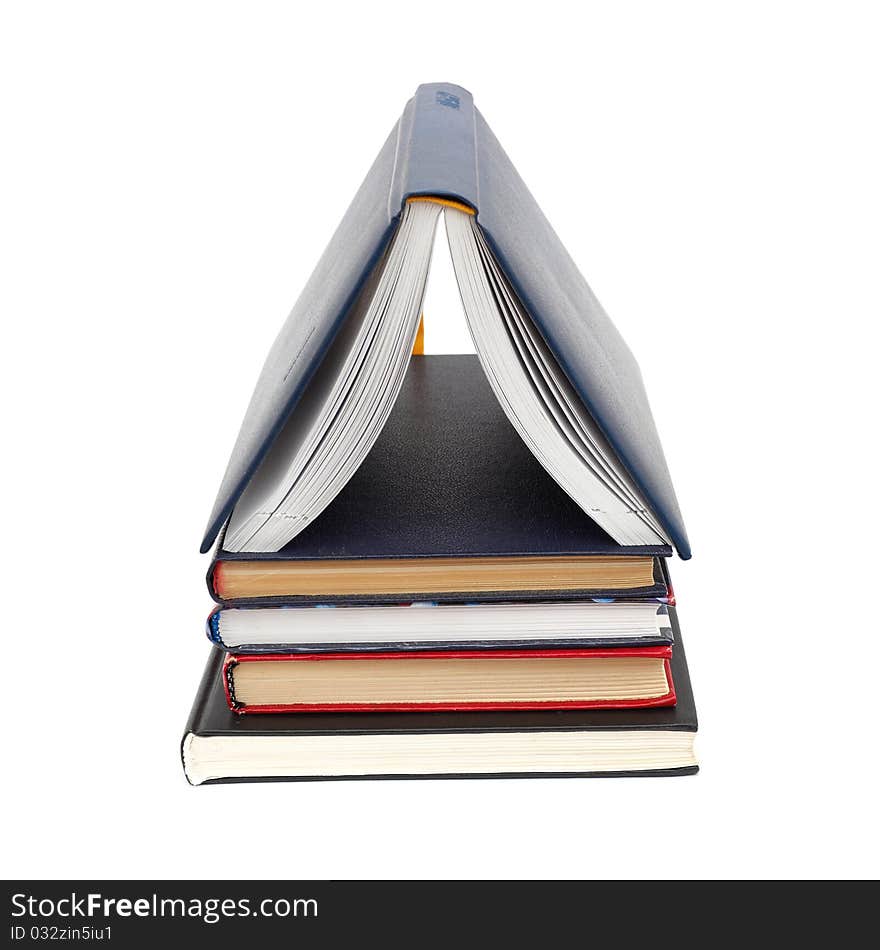 House made with books piled on white background