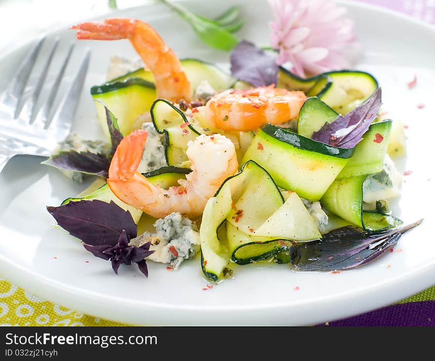 Tasty prawns appetizer with zucchini, cheese and basil