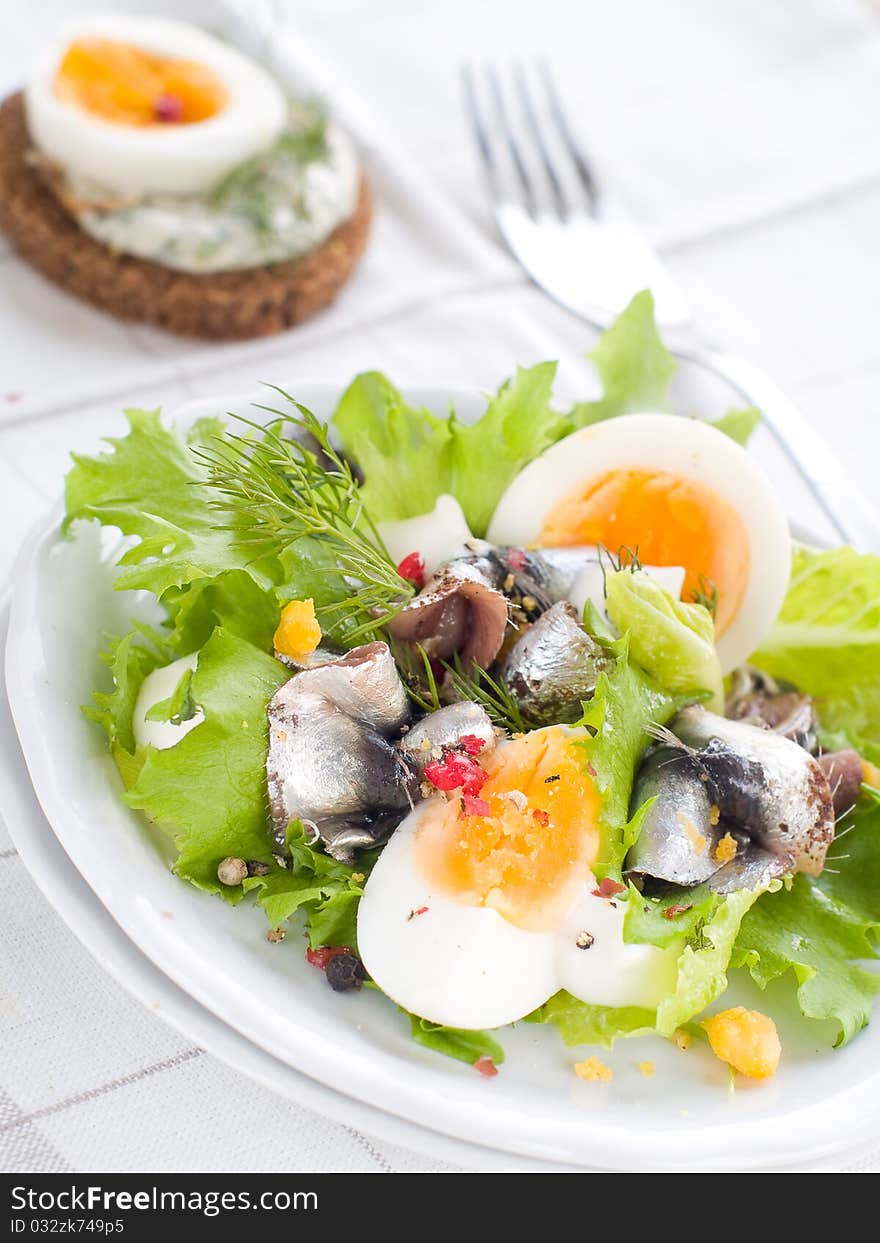 Salad with lettuce, eggs and anchovy on kitchen towel