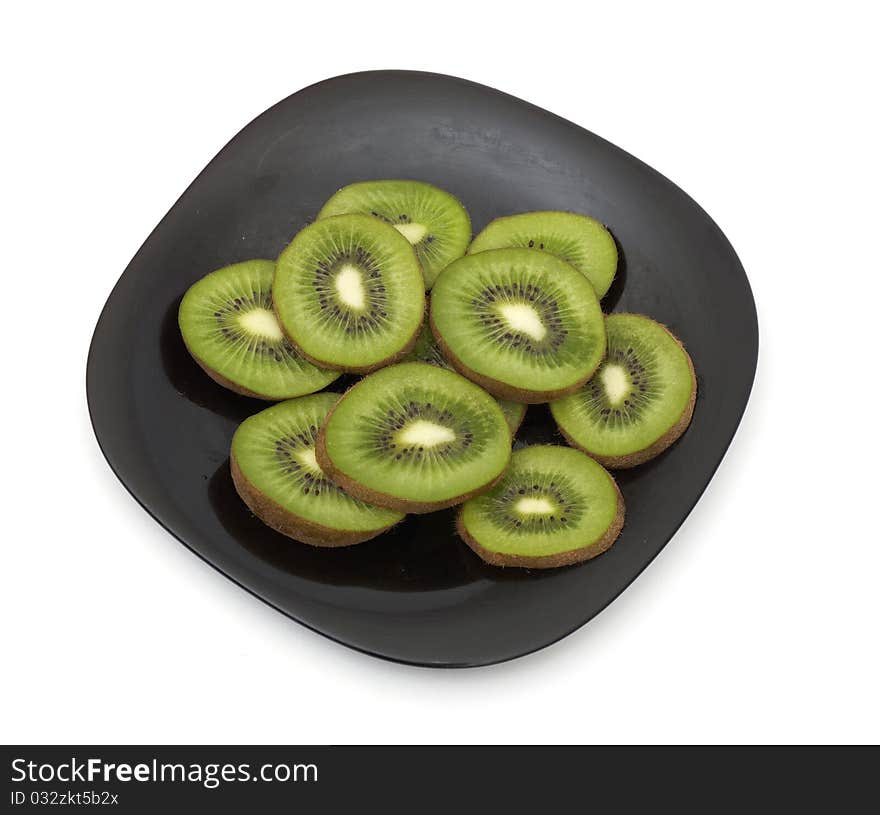 Cut kiwi in plate isolated on white background