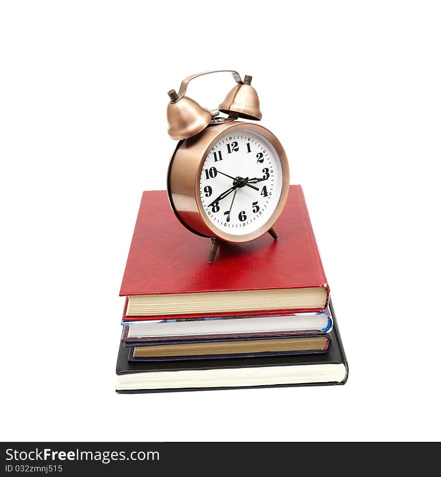 Clock and books on a white background