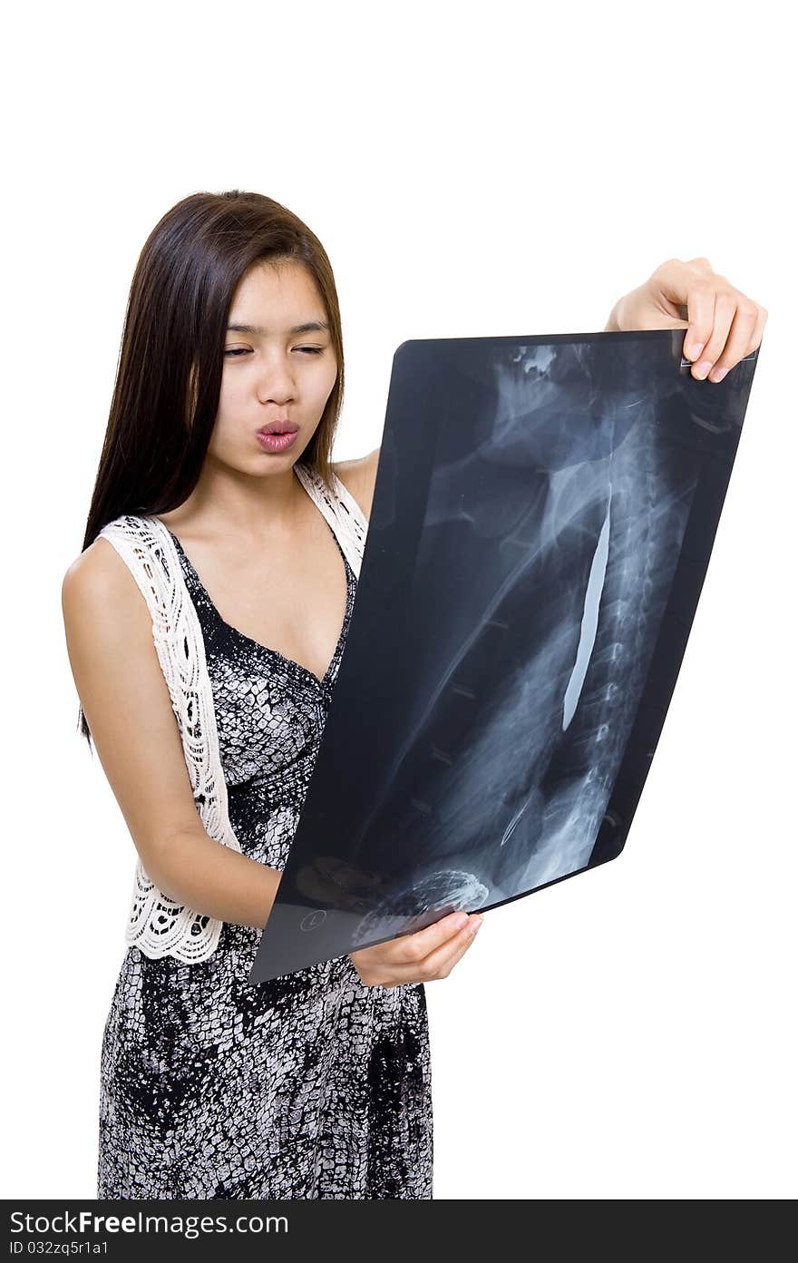 Woman seems to be concernded about an x-ray picture, isolated on white background. Woman seems to be concernded about an x-ray picture, isolated on white background