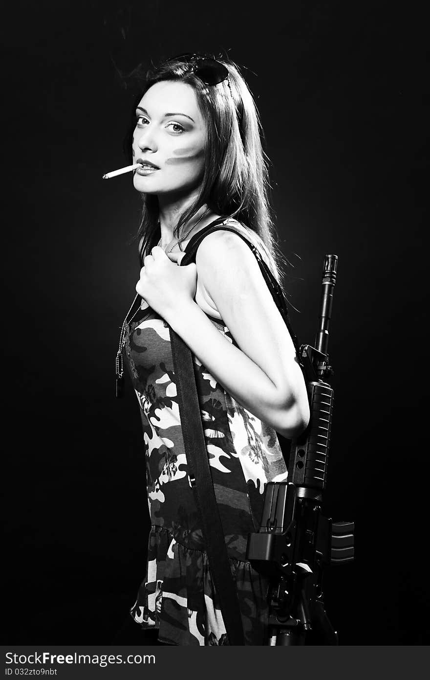 Attractive and sexy spy woman with assault rifle