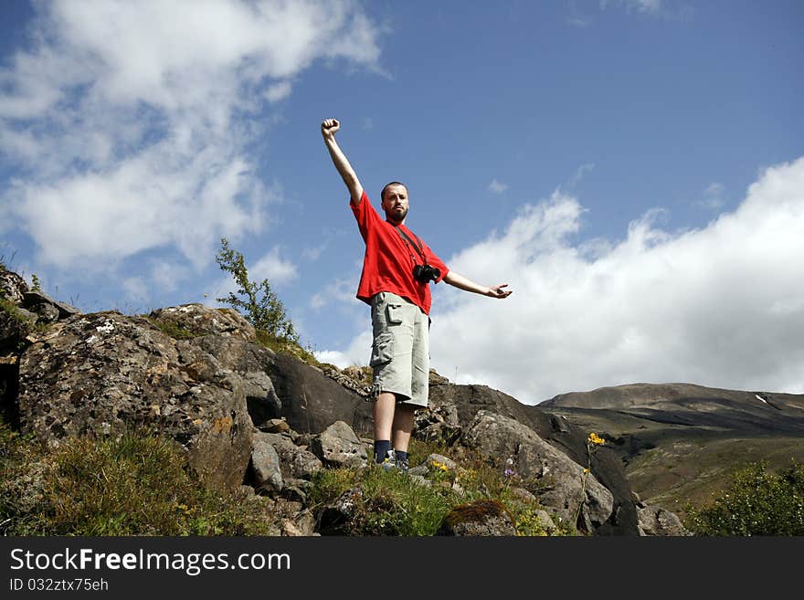 Young male traveller, photographer enjoying the beautiful view of mountains in Iceland