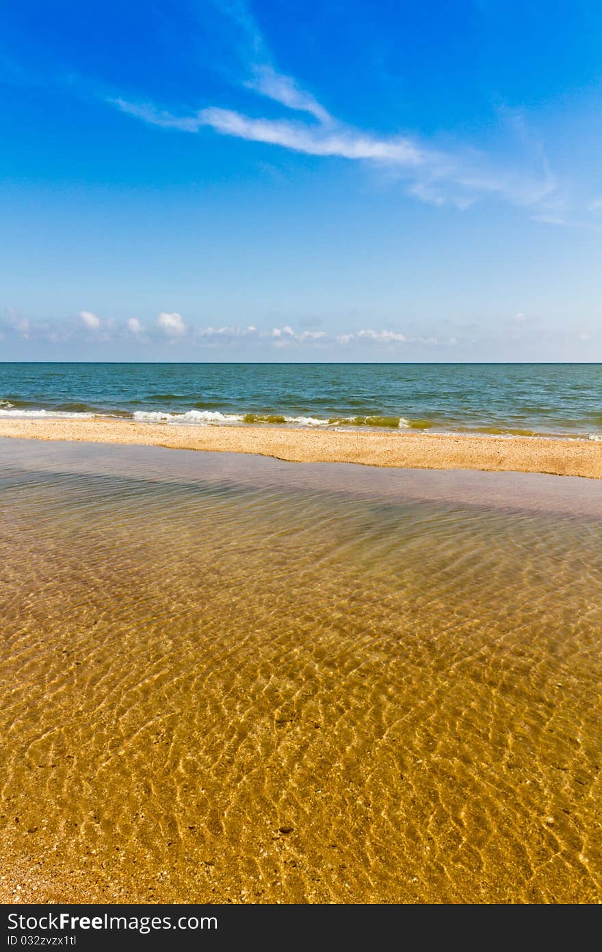 Sand beach, sea and blue sky