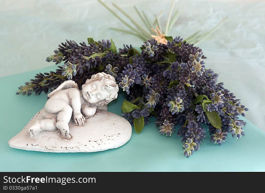 Still Life of Cupid with flowers depicting romance and love. Still Life of Cupid with flowers depicting romance and love