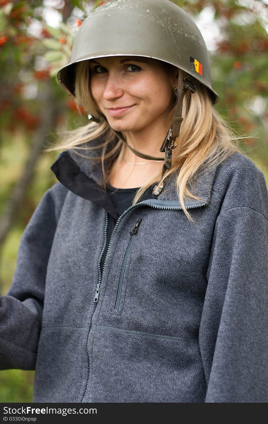 Portrai of beautiful smiling young girl in a helmet with mountain ash in fall park. Portrai of beautiful smiling young girl in a helmet with mountain ash in fall park