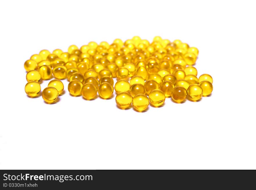 Photo of the yellow capsules on white background