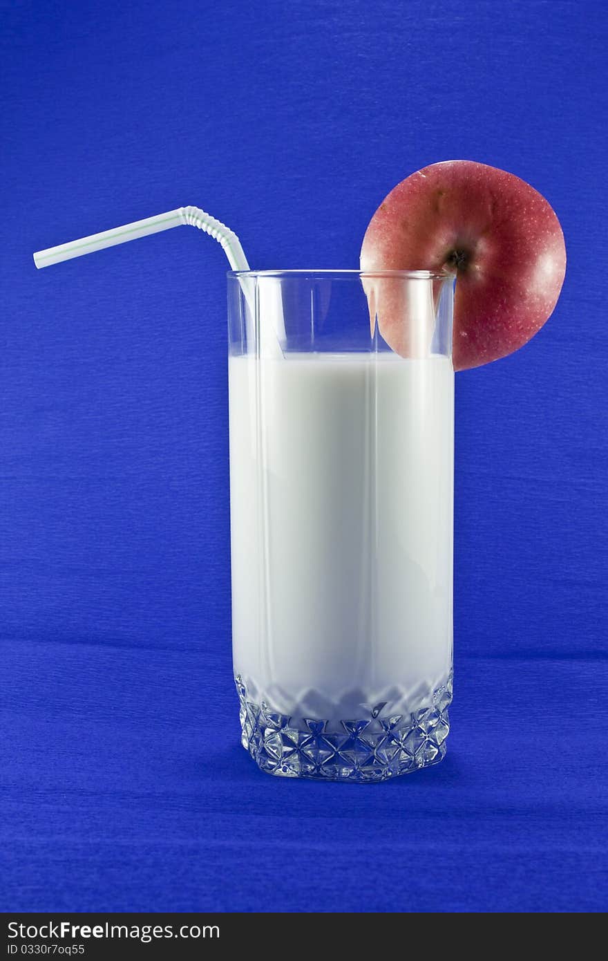 Milk in a glass with a blue background. Milk in a glass with a blue background