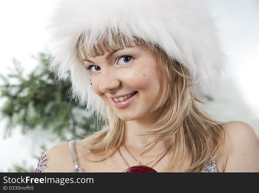 The cheerful Girl in a white fluffy cap. The cheerful Girl in a white fluffy cap