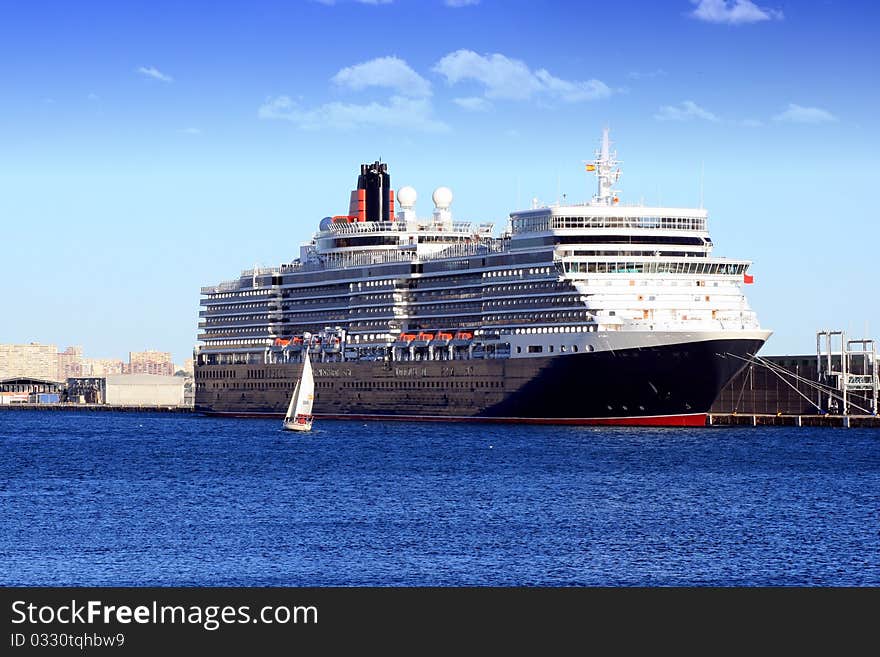 Luxury cruise tied up in Alicante with a sailing boat